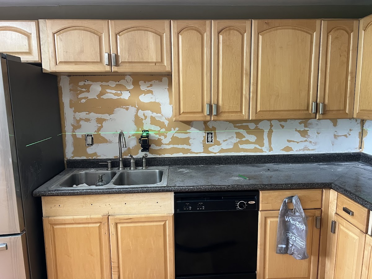 Kitchen backsplash preparation with drywall repair and laser leveling