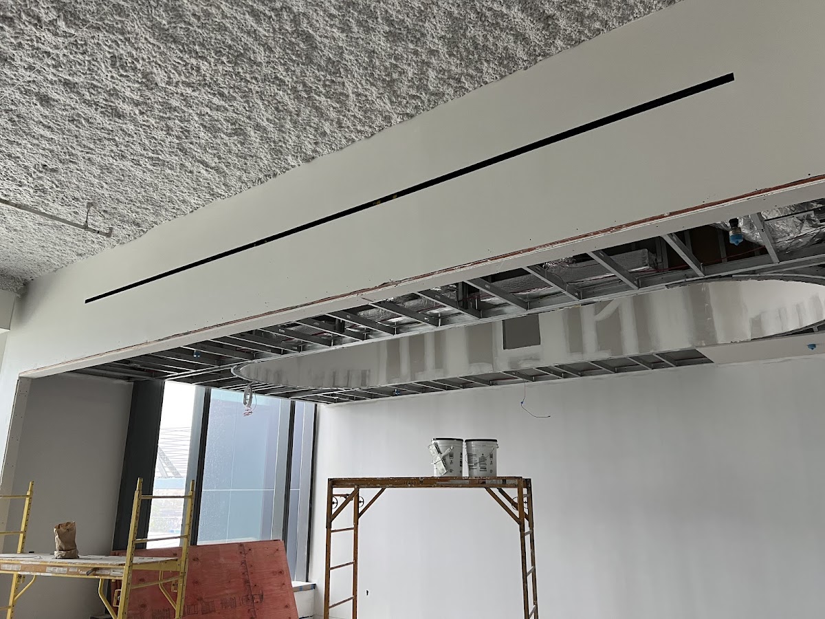 Commercial drywall and ceiling installation by Yunisbel S Remodeling showing professional metal framing and joint compound work